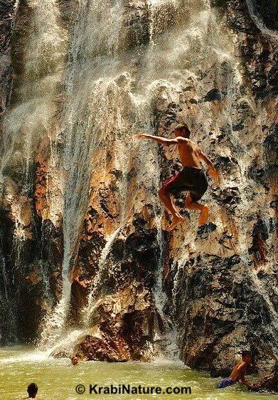 Boy jumping from Ko Samui waterfall in Surat.