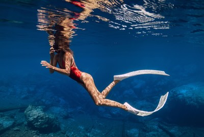 Young woman snorkeling in waters around Phi Phi Island.