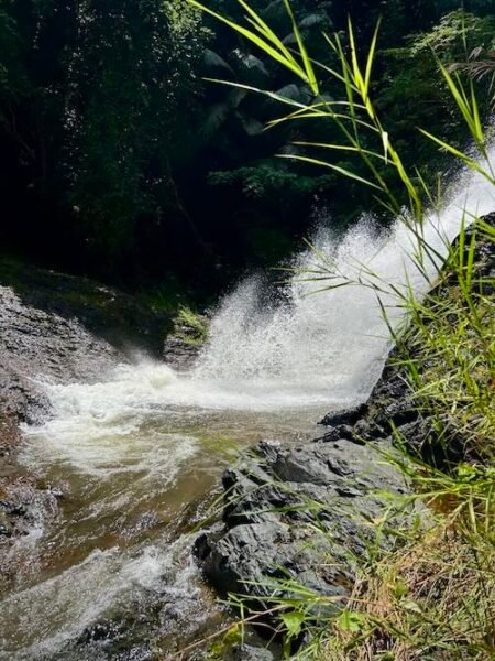 Close up shot of rushing water over Huay To Waterfall in Krabi.