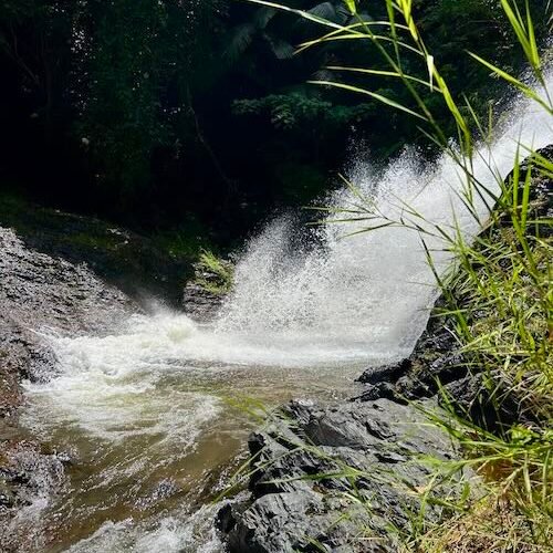 Close up shot of rushing water over Huay To Waterfall in Krabi.