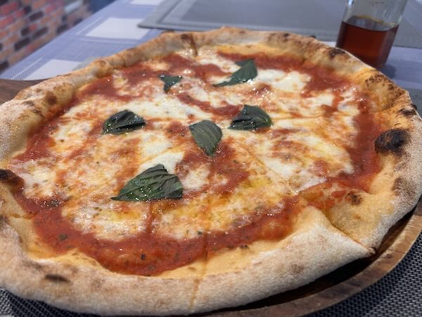 Whole margherita pizza at Pizzeria Napoli.