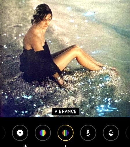 IPhone editing of photo of woman sitting in blue plankton at the beach